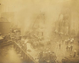 Item #18163 Firefighting scene showing dockside building on fire, being put out by hose and...