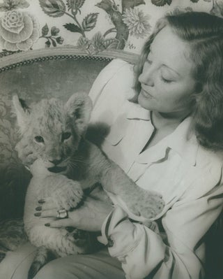 Item #222241 Portrait photograph of Tallulah Bankhead, with her lion cub Winston Churchill....