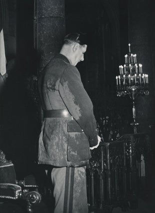 Item #232457 Photograph of a rain-soaked Charles de Gaulle praying in the Cathedral of Notre...