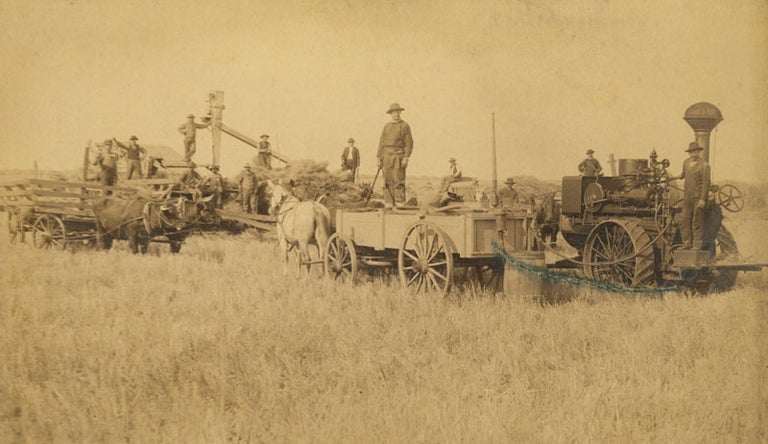 Item #234795 Albumen photograph of wheat harvest with steam-powered thresher and thirteen laborers. Dakota Territory, Caswell, illiam.