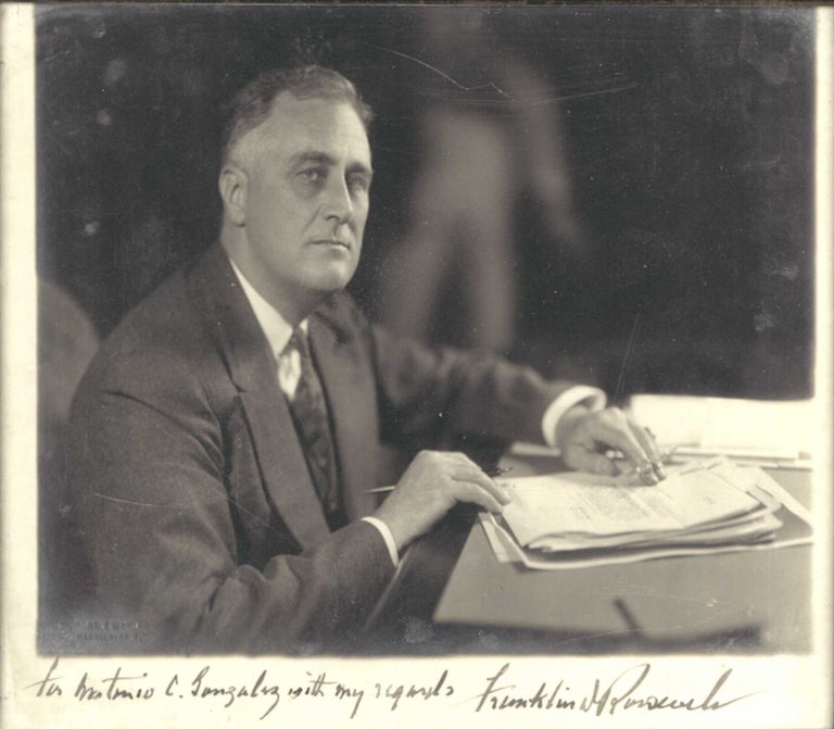 Photographic Portrait of the President at his desk, signed in ink below, as President, and inscribed "For Antonio C. Gonzalez with my regards, Franklin D. Roosevelt"