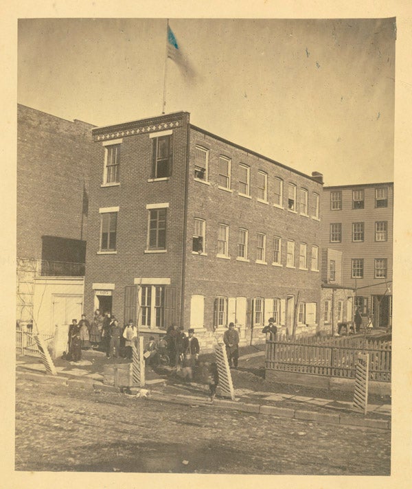Item #30474 Fine original photograph of 605 West 52nd Street, New York City, showing a brick three story building, with a gathering of people outside facing the camera. New York Photograph.