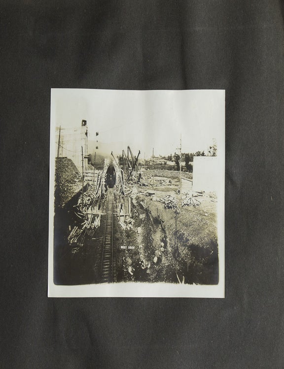 Album with 87 photographs depicting construction of the Ashokan reservoir, which supplies water to New York City, with multiple views of excavation machinery, compressors, special aqueduct and screen chamber, the spillway, tunnels, and picturesque scenes of local buildings