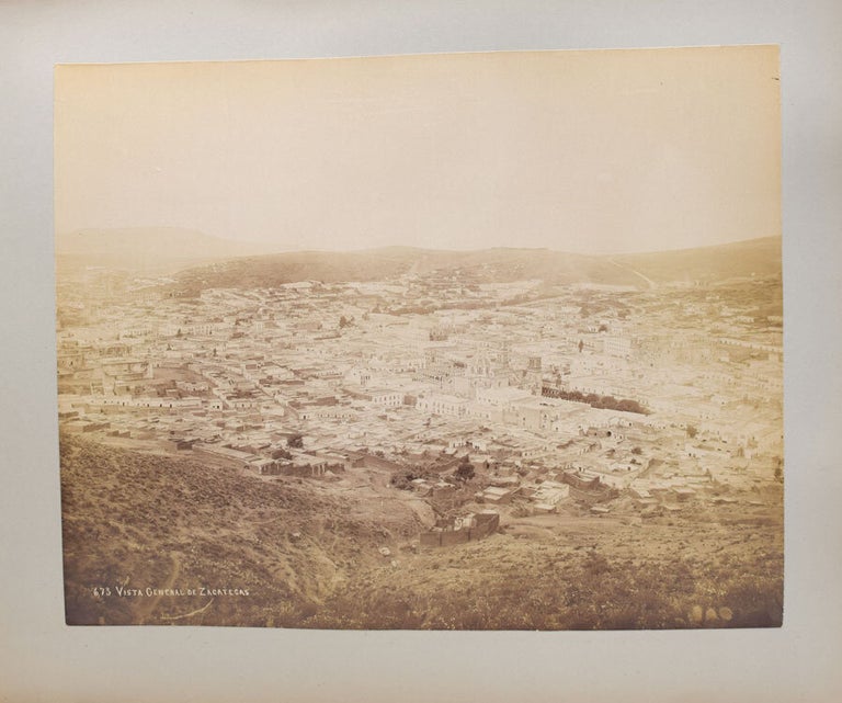 Album of Japanese 8 hand-coloured photographs and 14 others mostly Mexican including birds eye view of the city of Zacatecas, Statues of Guitlahuac, Hotel del Jardin, water carere, La Viga tipped into an album