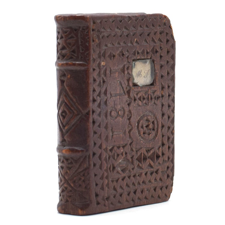 Item #320761 Chip-carved wooden book-form, dated 1781 on upper cover with small inlaid manuscript initials M.J. under glass, with 4 holes hand-drilled into the top likely for use as a quill holder. Folk Art.
