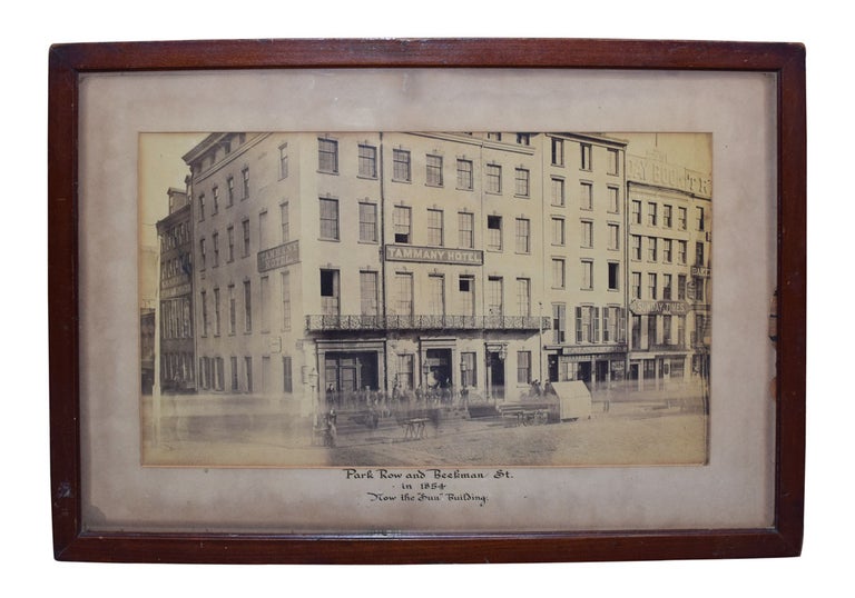 Item #320972 Tammany Hotel [albumen photograph of Park Row in Printing House Square showing the Tammany Hotel with a group of men in front, with signs for Tammany Hall M.[ichael] Halpin, L.S. Lawrence & Co., Sunday Times, Pewter Mug and on the far left in Hebrew "Kosher" Restaurant]. New York City.