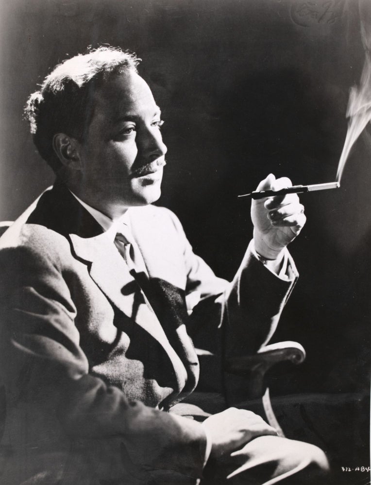 Tennessee Williams, seated and smoking, photograph from the National Film Archive
