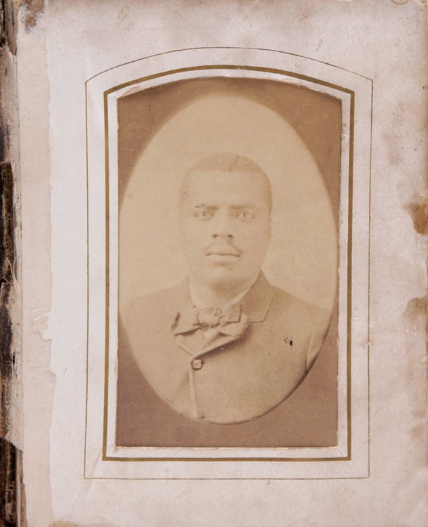 [Small album of tintypes and cdvs of African American men, women and children, plus cdvs of prints of Lincoln reading to Tad and Lincoln on he death bed]