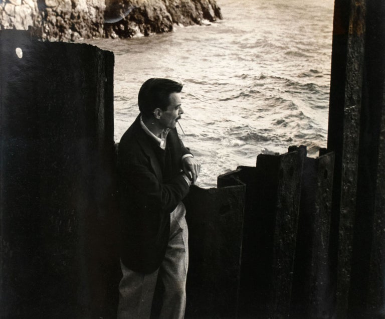 Item #353289 Photo of Weldon Kees under the Golden Gate Bridge, early 1955. Weldon Kees, William Heick.