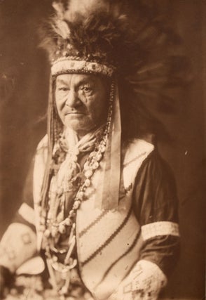 Item #365588 [Seated studio photograph of a Native American with scar over is left eye, in vest...