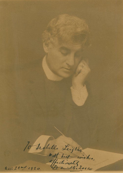 Item #38054 Portrait photograph of David Belasco writing with quill pen. David Belasco, The Misses Selby.